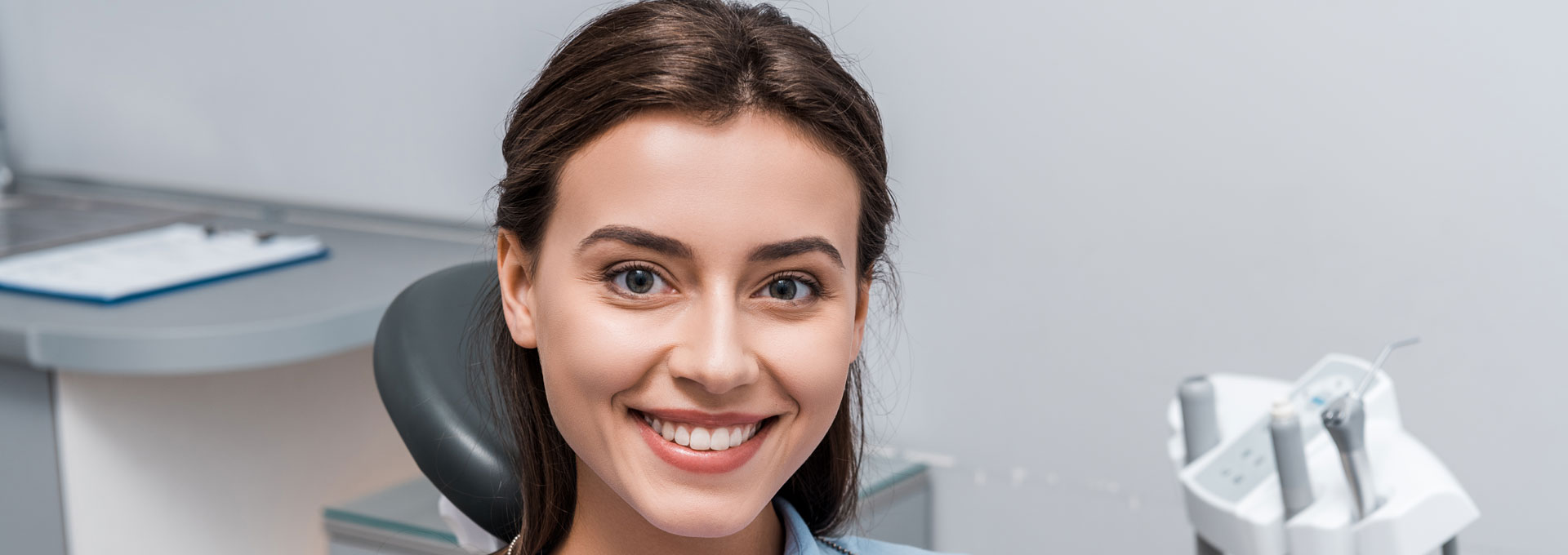 Beautiful woman sitting and smiling in dental clinic